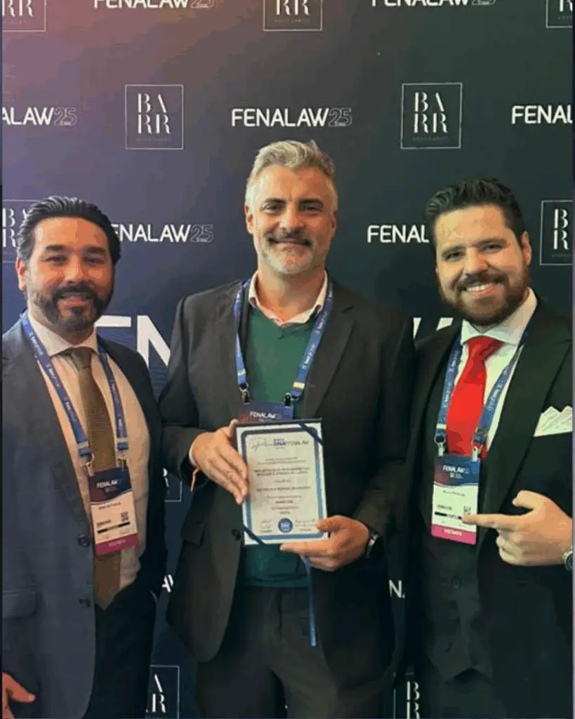 Três homens com prêmio em evento.